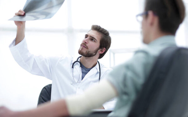 orthopedist examining a radiograph of a patient