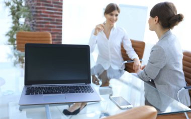 Bir iş adamının bilgisayarında bilgisayar ve akıllı telefon.