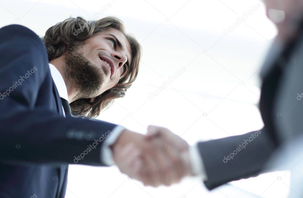 Successful business people handshaking after good deal.