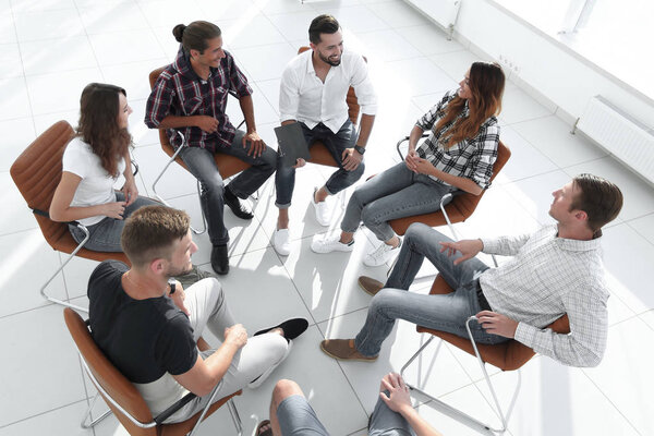 business team holds a meeting in the lobby of the office