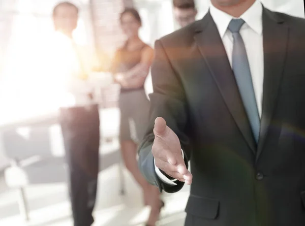 Successful businessman giving a hand — Stock Photo, Image