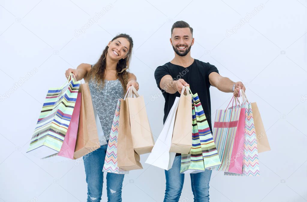 young couple shows shopping bags