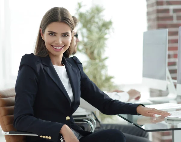 Joven mujer de negocios sentada en el escritorio —  Fotos de Stock