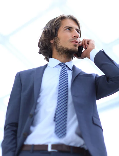 Businessman talking on mobile .isolated on white. — Stock Photo, Image