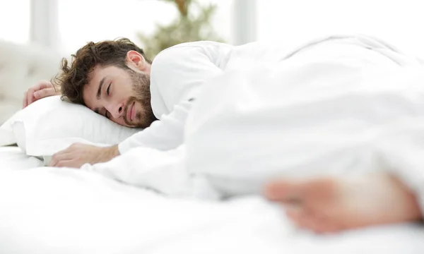 Closeup.the tired men sleep soundly on the bed — Stock Photo, Image