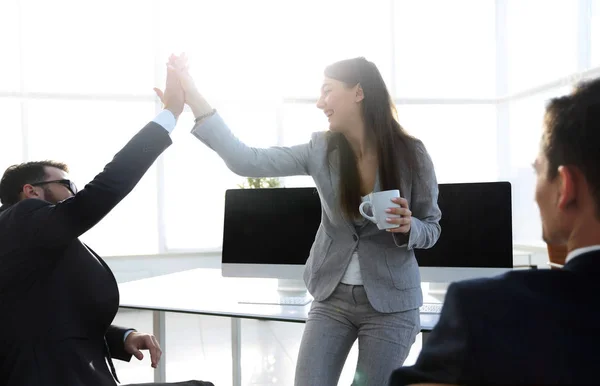 Smiling colleagues giving each other high five — Stock Photo, Image