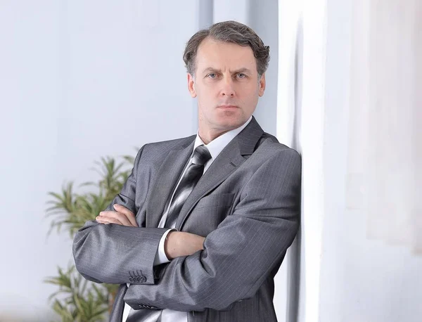 Successful businessman on background of office. — Stock Photo, Image