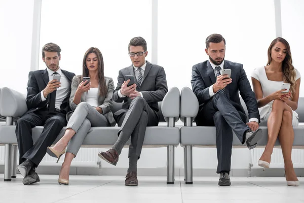 Geschäftskollegen mit ihren Smartphones auf dem Büroflur — Stockfoto