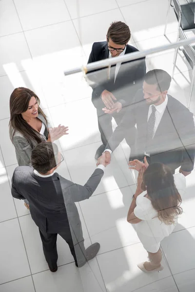 Handshake business partners behind the glass door — Stock Photo, Image