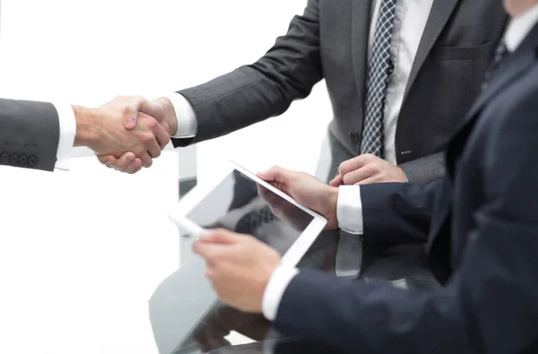 Two confident businessmen shaking hands during a meeting in the — Stock Photo, Image