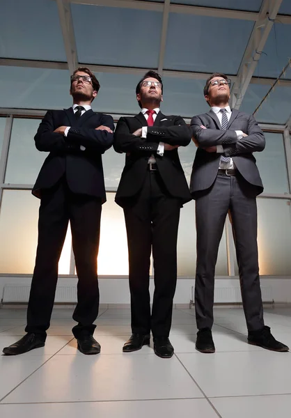 Three confident businessmen look forward — Stock Photo, Image