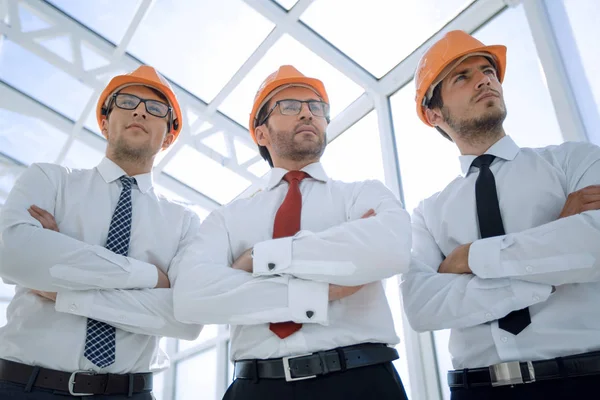 Close up.a group of architects and designers in protective helmets — Stock Photo, Image