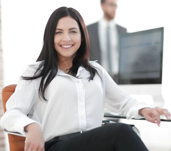 Successful young business woman sitting at workplace — Stock Photo, Image