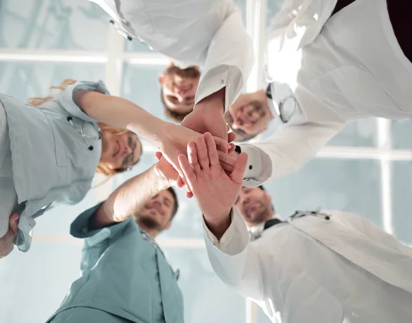 Health care workers demonstrating unity, bottom view — Stock Photo, Image