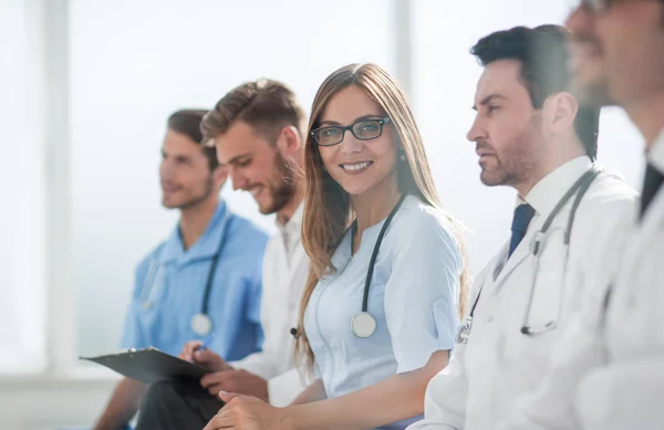 Portrait of female doctor with colleagues at meeting — Stock Photo, Image