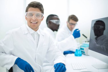 modern bilim adamı bir bilgisayar monito önünde oturan