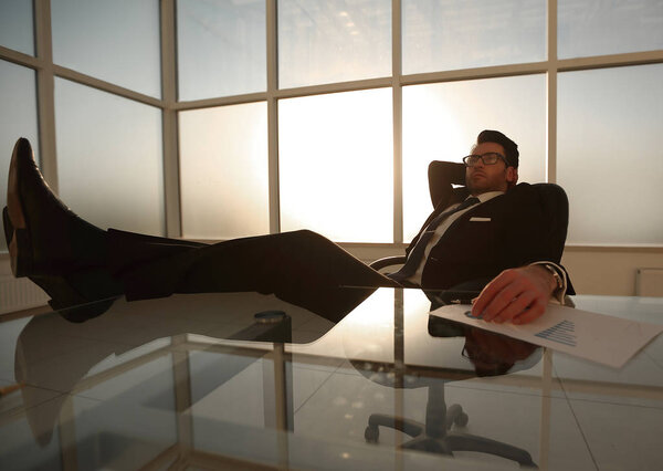 successful businessman relaxing at the table