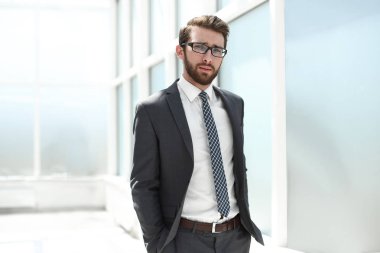 parlak bir ofiste ayakta başarılı iş adamı