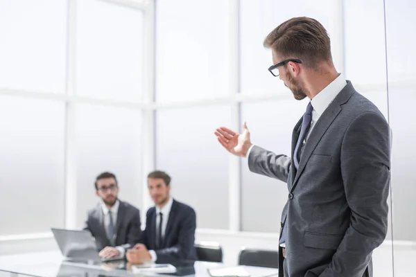 Businessman pointing to his office — Stock Photo, Image