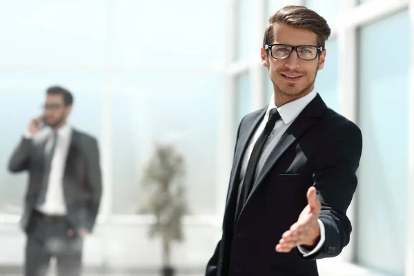 Successful businessman reaching out for a handshake — Stock Photo, Image