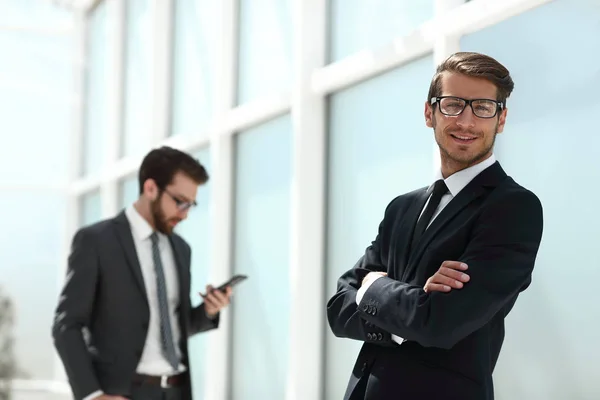 Successful businessman on the background of the office — Stock Photo, Image