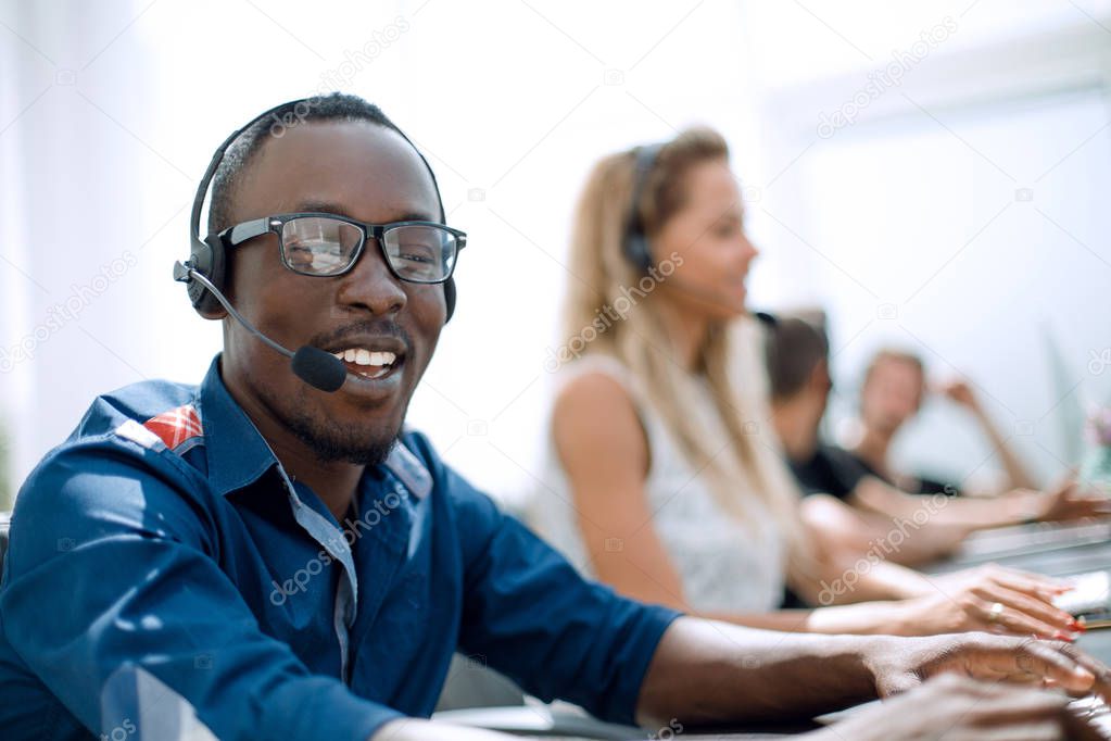 call center employee on the background of colleagues