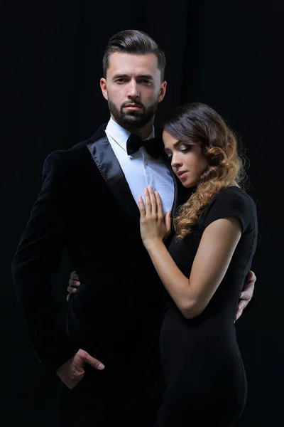 Portrait of fashion couple on black background — Stock Photo, Image