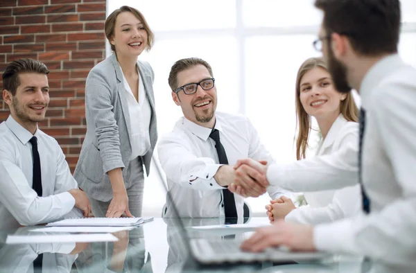 Apretón de manos a los socios financieros en Desk — Foto de Stock