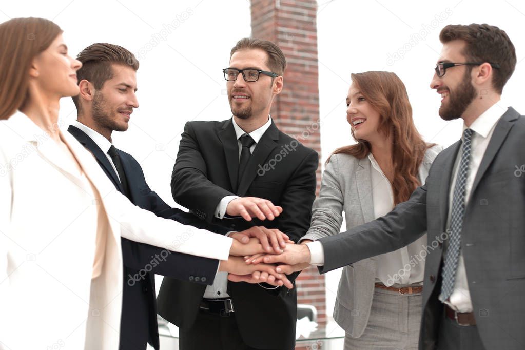 successful business team putting their palms togethe