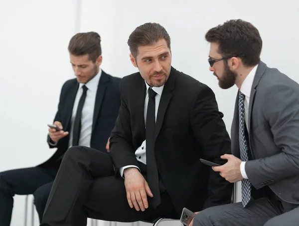 Mitarbeiter diskutieren Neuigkeiten, sitzen auf dem Flur des Büros — Stockfoto