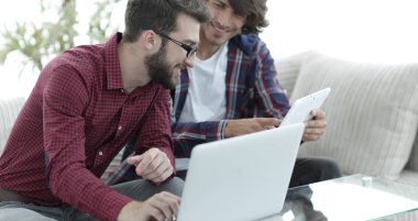 İki web tasarımcıları bir proje bir dizüstü bilgisayar önünde tartışmaya portresi