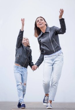 Yetişkin bir şekilde. Mutlu anne ve kız birlikte yürüyorlar.