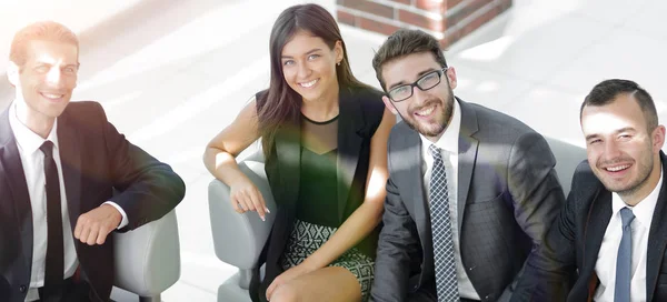 Portrait of successful business team sitting in office lobby — Stock Photo, Image