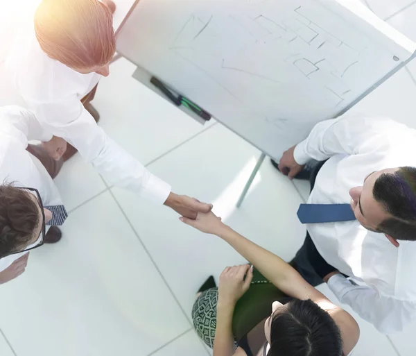 View from the top. the background image of a business handshake colleagues — Stock Photo, Image