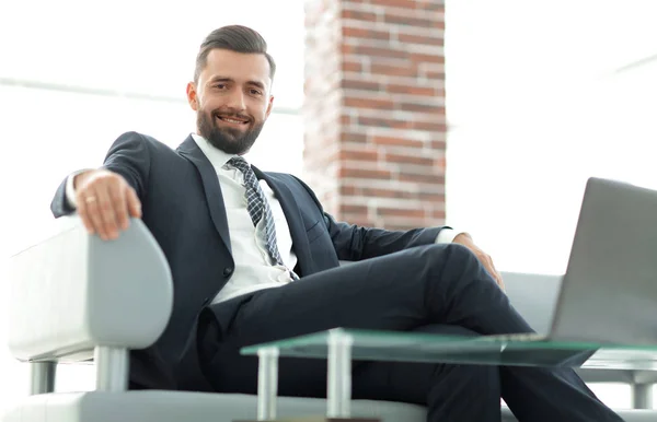 Portrait of a successful businessman sitting in the office lobby. — Stock Photo, Image