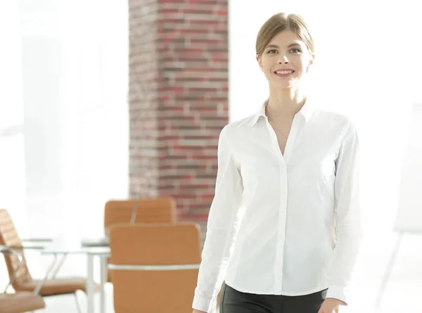 smiling young woman assistant is moving around the office.