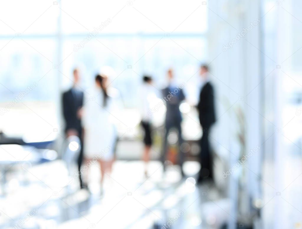 blurred image of business people standing in office.business background