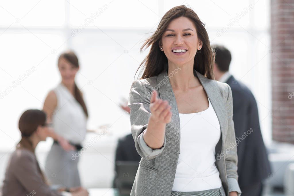 smiling business woman holding out her hand for a handshake