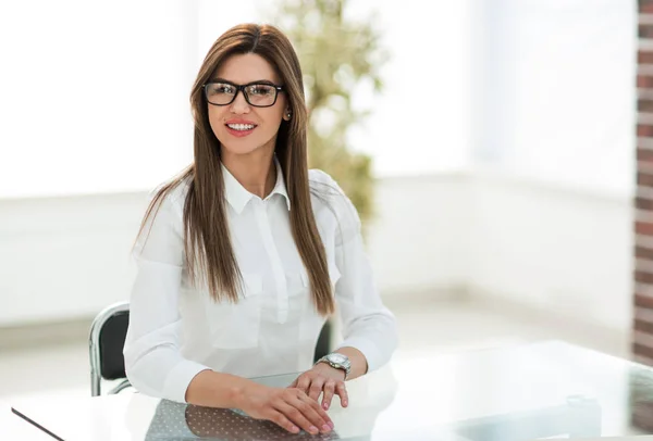 Sorrindo mulher de negócios sentado na mesa do escritório — Fotografia de Stock