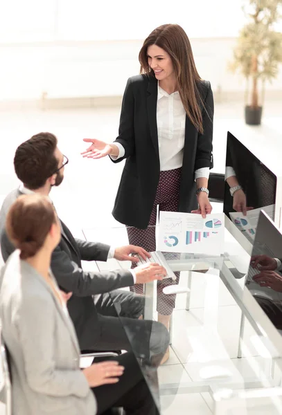 business woman discusses with the business team financial performance