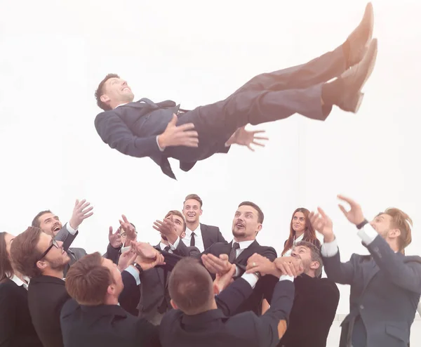 Large business team rocking their leader. — Stock Photo, Image