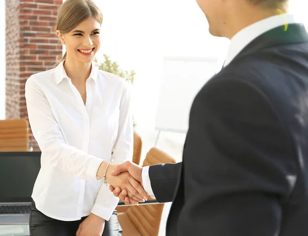 woman Manager welcomes the client with a handshake.