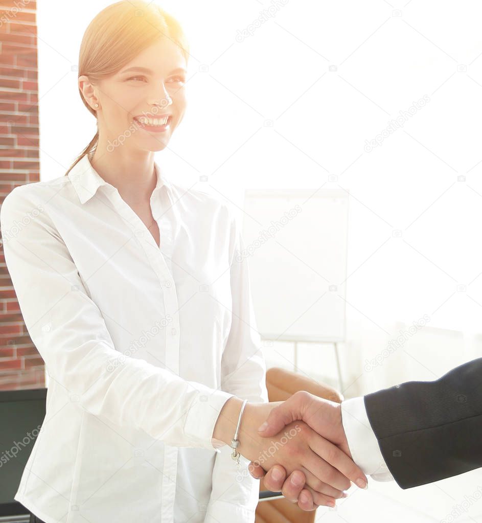 woman Manager welcomes the client with a handshake.