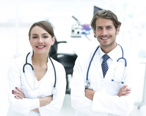 Retrato de dos exitosos médicos profesionales trabajadores en abrigos — Foto de Stock