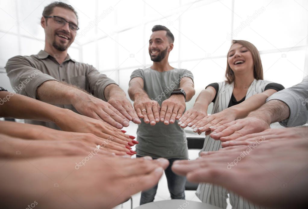 close up.young business team forming a circle of hands