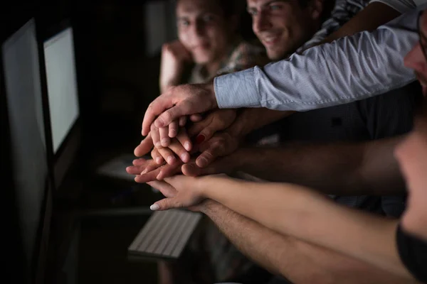Close up. Young active office workers hold their hands together — стоковое фото