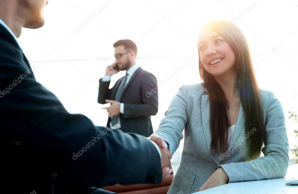 business woman shaking hands with a business partner.