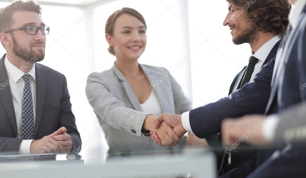 handshake business partners for their Desk