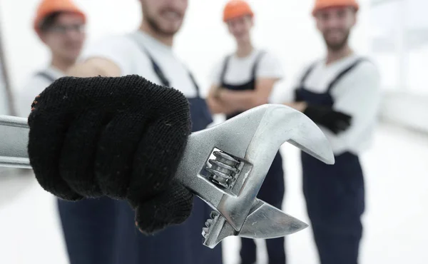Nahaufnahme. der Schraubenschlüssel in den Händen der Bauarbeiter — Stockfoto