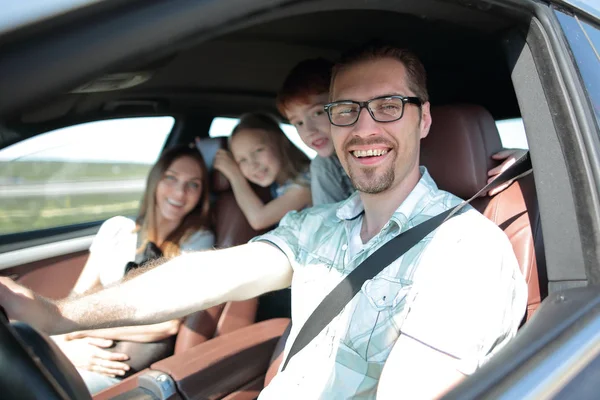 Side view.happy father driving a car — Stock Photo, Image